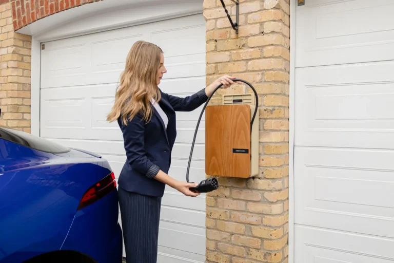 Homeowner plugging an electric car into a wall-mounted Level 2 charger